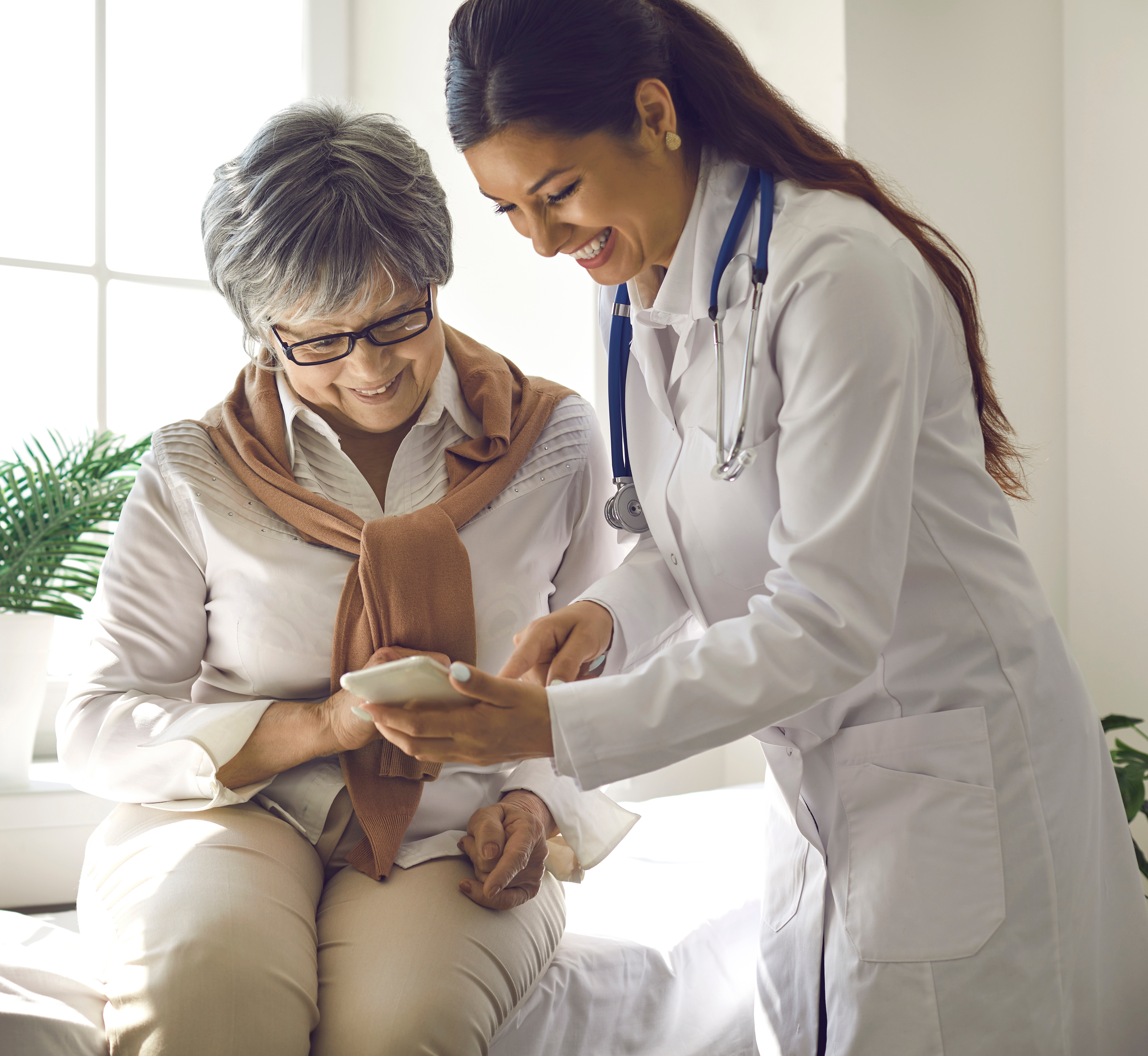 Doctor teaches patient to use mobile healthcare app